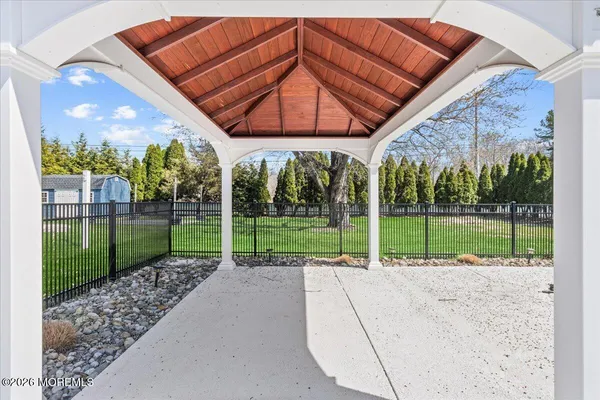 a view of a backyard with wooden fence