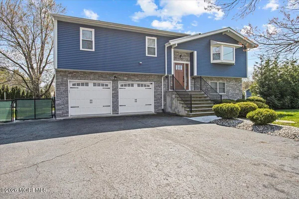 a view of a house with a yard and garage