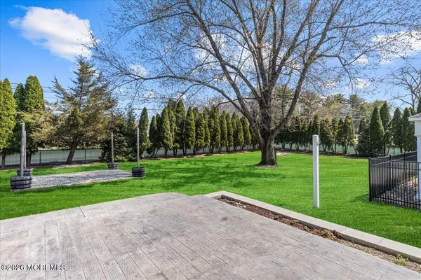 a view of a big building with a big yard and large trees