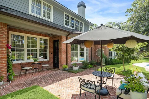 a view of a house with backyard sitting area and garden