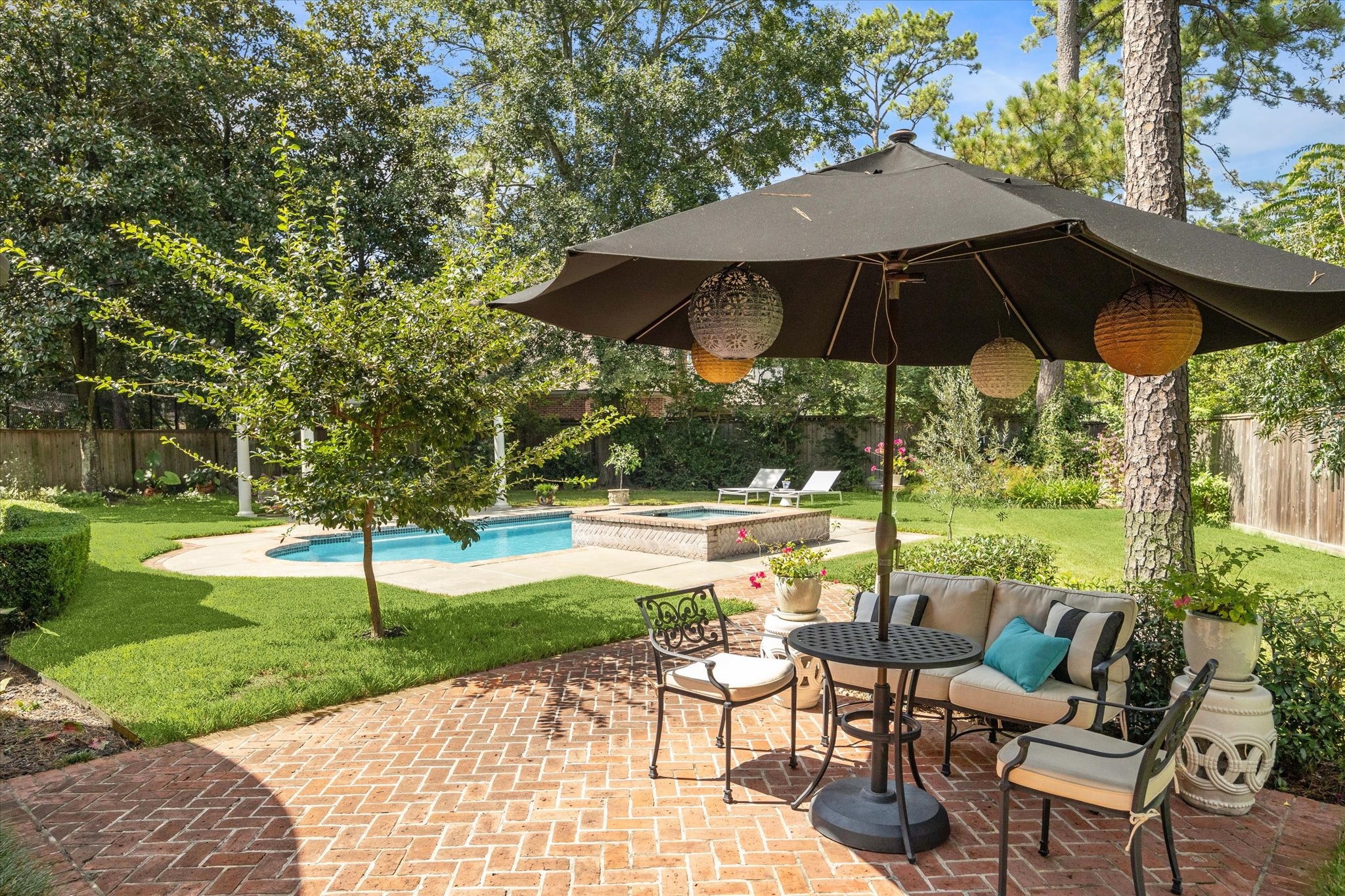 2 Blalock Pines Court Hedwig Village, TX 77024 - Photo 14 of 44 a view of a table and chairs under an umbrella