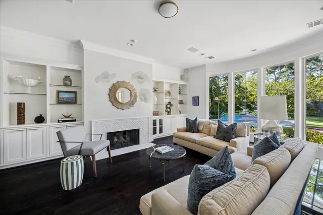 a living room with furniture a fireplace and a large window