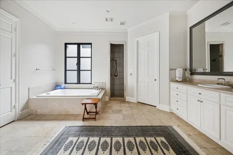 a spacious bathroom with a tub and a sink