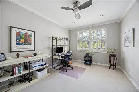 a view of a livingroom with workspace and a window