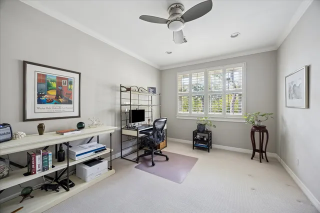 a view of a livingroom with workspace and a window