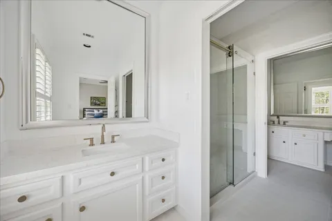 a bathroom with a double vanity sink and mirror