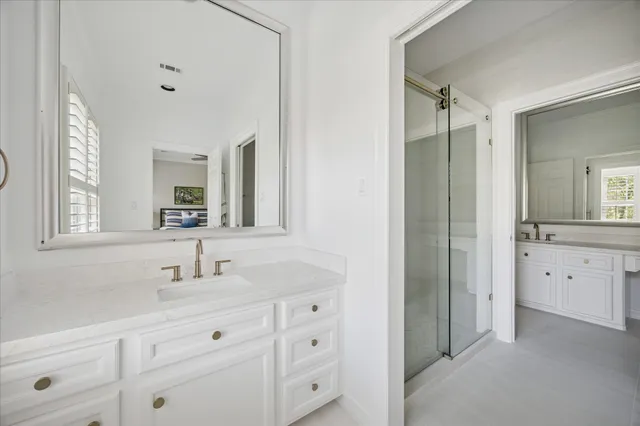 a bathroom with a double vanity sink and mirror
