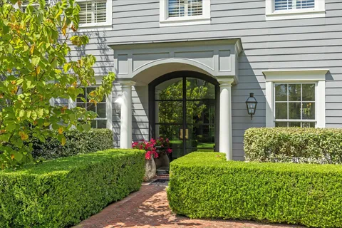 a front view of a house with garden