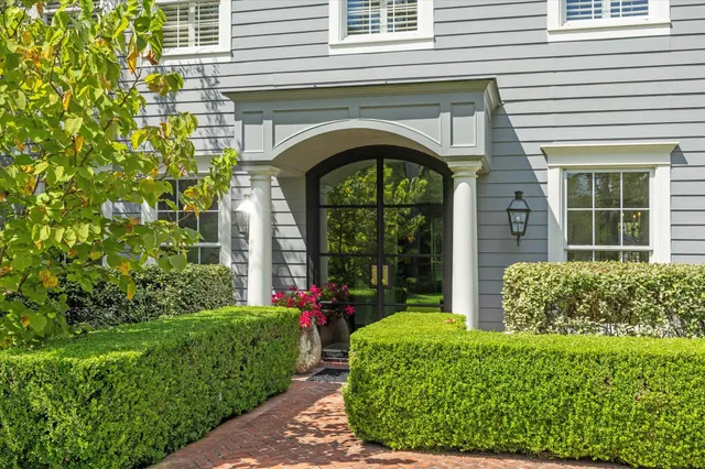 a front view of a house with garden
