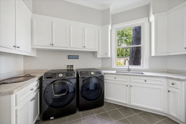 a utility room with sink dryer and washer