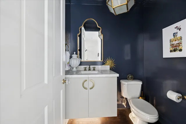 a white toilet sitting next to a bathroom sink