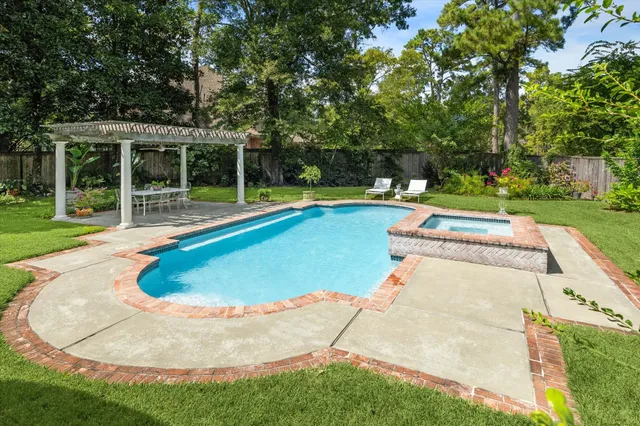 a view of a house with swimming pool and yard