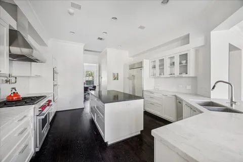 a kitchen that has a sink and a stove