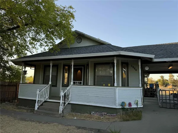a view of a house with a yard and sitting area