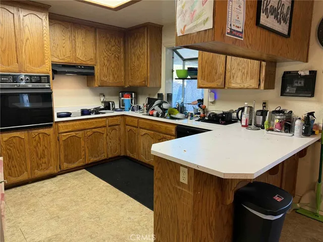 a kitchen with a sink a stove and cabinets