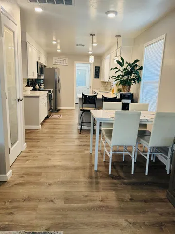 a kitchen with stainless steel appliances kitchen island granite countertop a sink a stove top oven a counter space and cabinets