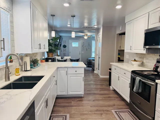 a bedroom with a bed and painting on the wall