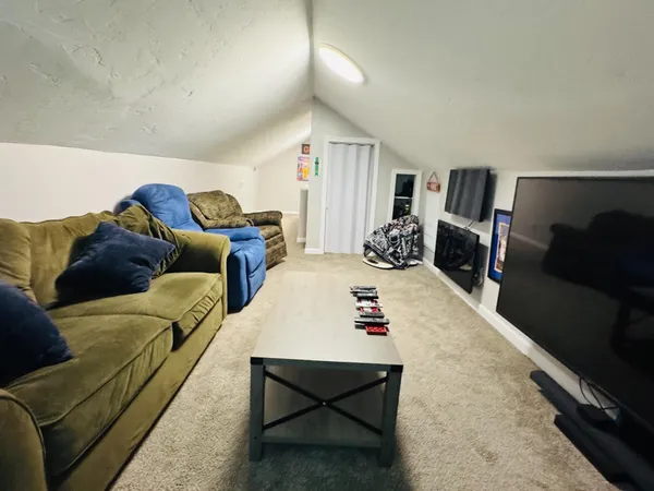 a bedroom with furniture and a wooden floor