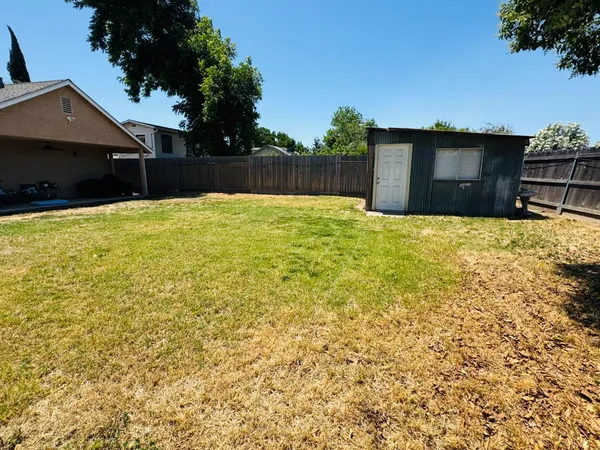 a view of a backyard of the house