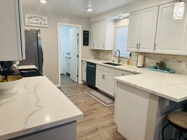 a kitchen with a sink stove and refrigerator