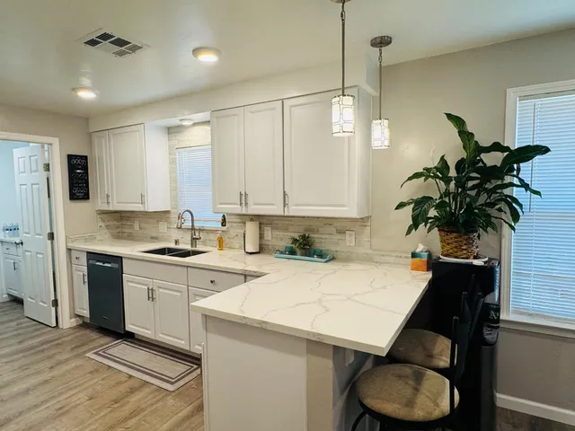 a kitchen with a sink a stove and cabinets