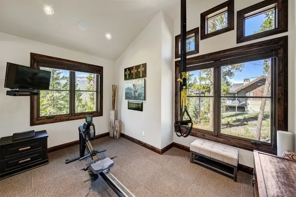 a view of a livingroom with workspace and a window