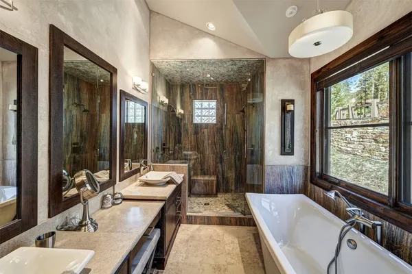 a large bathroom with a large tub and sink