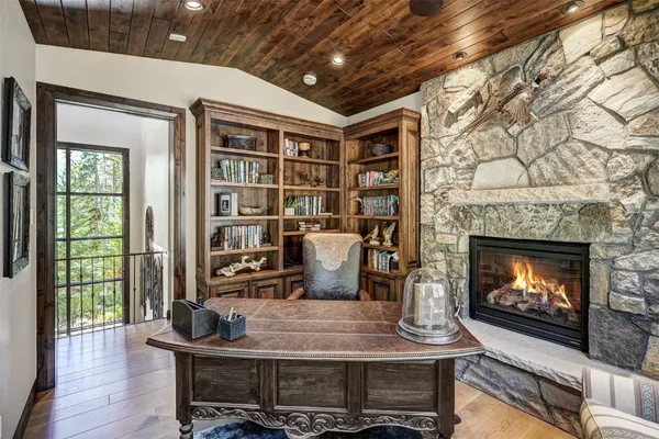 a living room with fireplace furniture and a floor to ceiling window