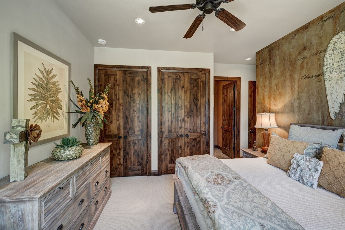 67 Rounds Road Breckenridge, CO 80424 - Photo 28 of 47 a bedroom with a large bed and a chandelier