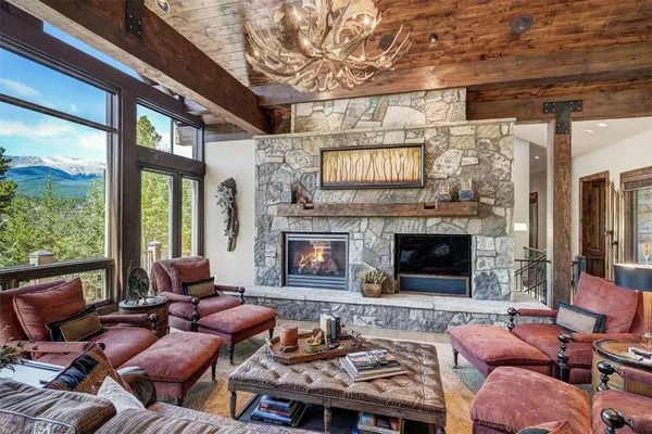 a living room with furniture fireplace and a large window