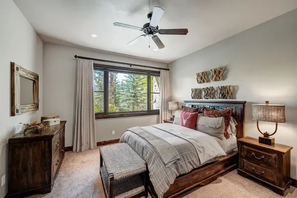 a bedroom with a bed and a chandelier