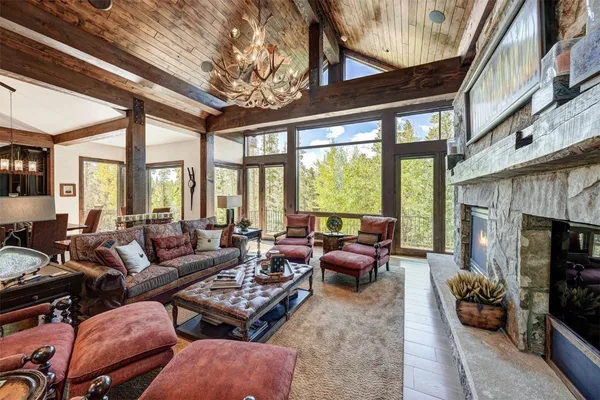 a living room with furniture a fireplace and a large window