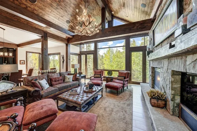 a living room with furniture a fireplace and a large window