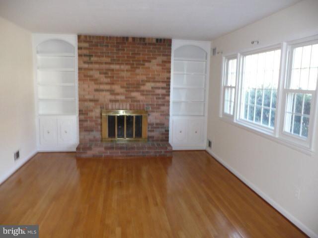625 Cleveland Road Linthicum Heights, MD 21090 - Photo 12 of 28 an empty room with windows and fireplace