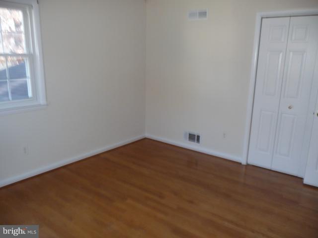 625 Cleveland Road Linthicum Heights, MD 21090 - Photo 14 of 28 a view of empty room with wooden floor and fan
