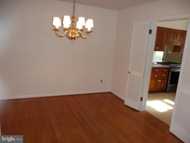 625 Cleveland Road Linthicum Heights, MD 21090 - Photo 21 of 28 wooden floor in an empty room with a window