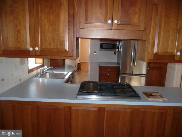 625 Cleveland Road Linthicum Heights, MD 21090 - Photo 4 of 28 a kitchen with granite countertop a sink a stove and cabinets