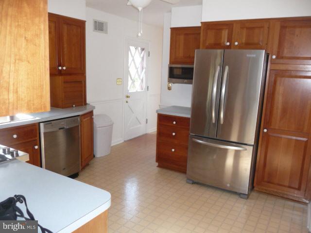 625 Cleveland Road Linthicum Heights, MD 21090 - Photo 5 of 28 a kitchen with stainless steel appliances a refrigerator and a stove