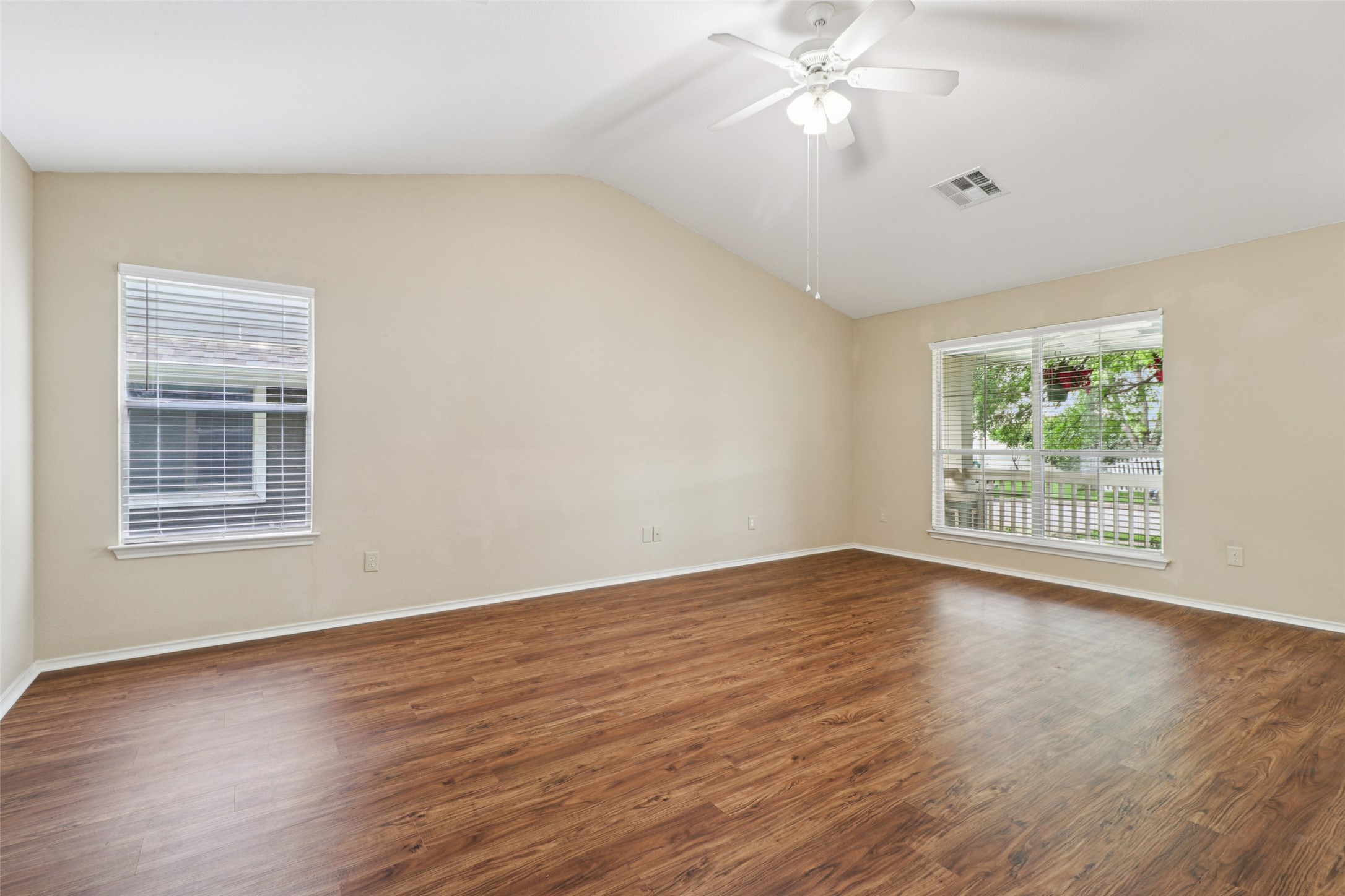 700 Scheel Road Kyle, TX 78640 - Photo 10 of 39 The living space features vaulted ceilings, rich wood-look flooring, and a ceiling fan