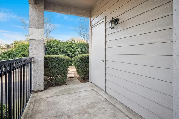 a view of a door and wooden floor in front of house