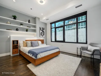 a bedroom with a bed and a large window