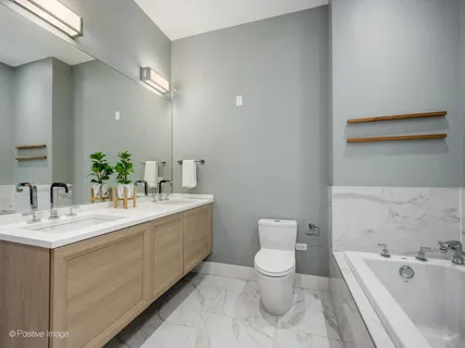 a bathroom with a sink a toilet and mirror