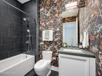 a bathroom with a sink toilet vanity tub and shower