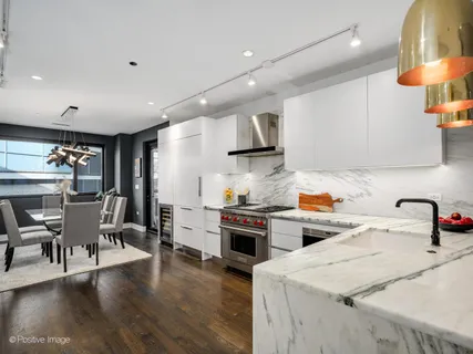 a kitchen with granite countertop a stove and a wooden floors