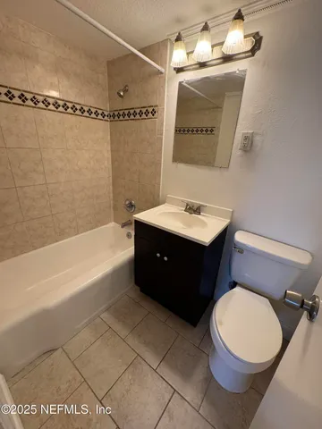 a bathroom with a sink toilet and mirror