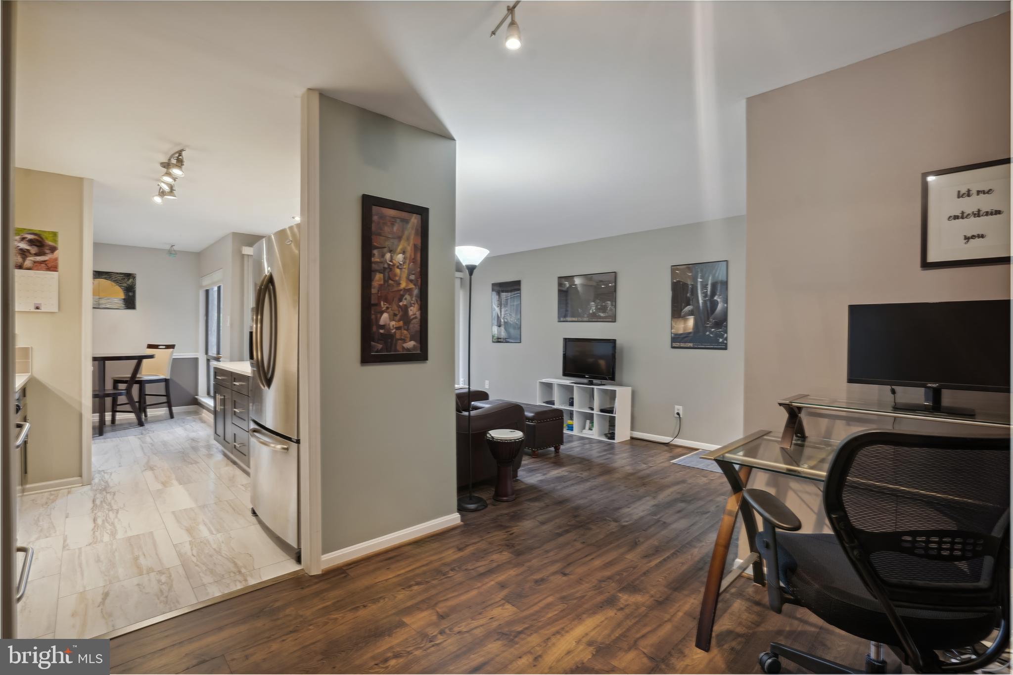 11204 Chestnut Grove Square, Unit 11204108 Reston, VA 20190 - Photo 12 of 40 a view of a livingroom with furniture and a flat screen tv