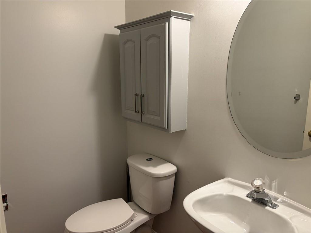 3089 Commons Crossing Snellville, GA 30078 - Photo 13 of 16 a bathroom with a toilet sink and mirror