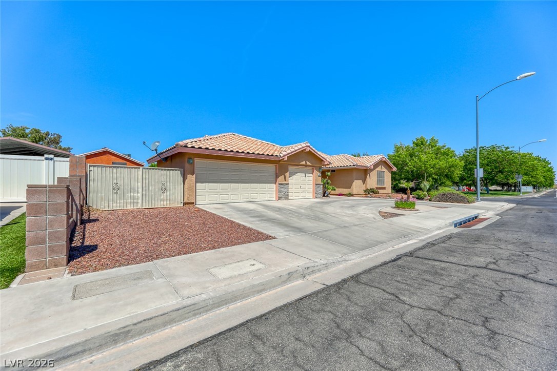 2001 Appaloosa Road Henderson, NV 89002 - Photo 5 of 44 This residence features a tiled roof and an attached garage, offering both style and convenience.