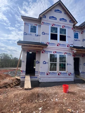 a view of a livingroom with furniture and staircase