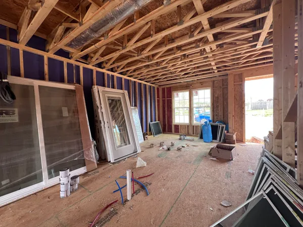 a bed sitting in a spacious bedroom next to a window